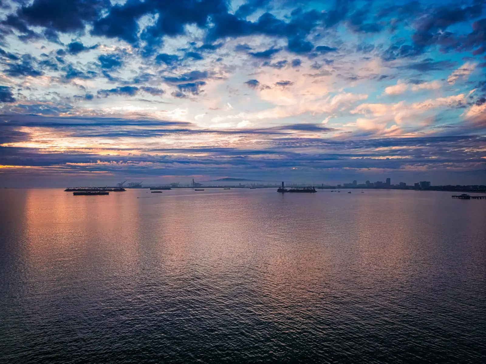 Cargo ships at anchor at dusk